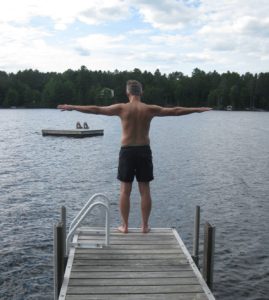 Phil dives into retirement (Phil on dock with arms outstretched)